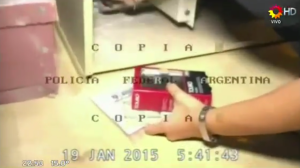 Una investigadora recoge pruebas sin guantes, según el video de la Policía Federal de Argentina. (Crédito: YouTube/PPT)