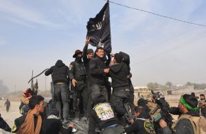 Militares de Iraq vapulean una bandera del grupo terrorista ISIS tras reconquistar la provincia de Diyala, a finales de enero del 2015. (Crédito: YOUNIS AL-BAYATI/AFP/Getty Images).