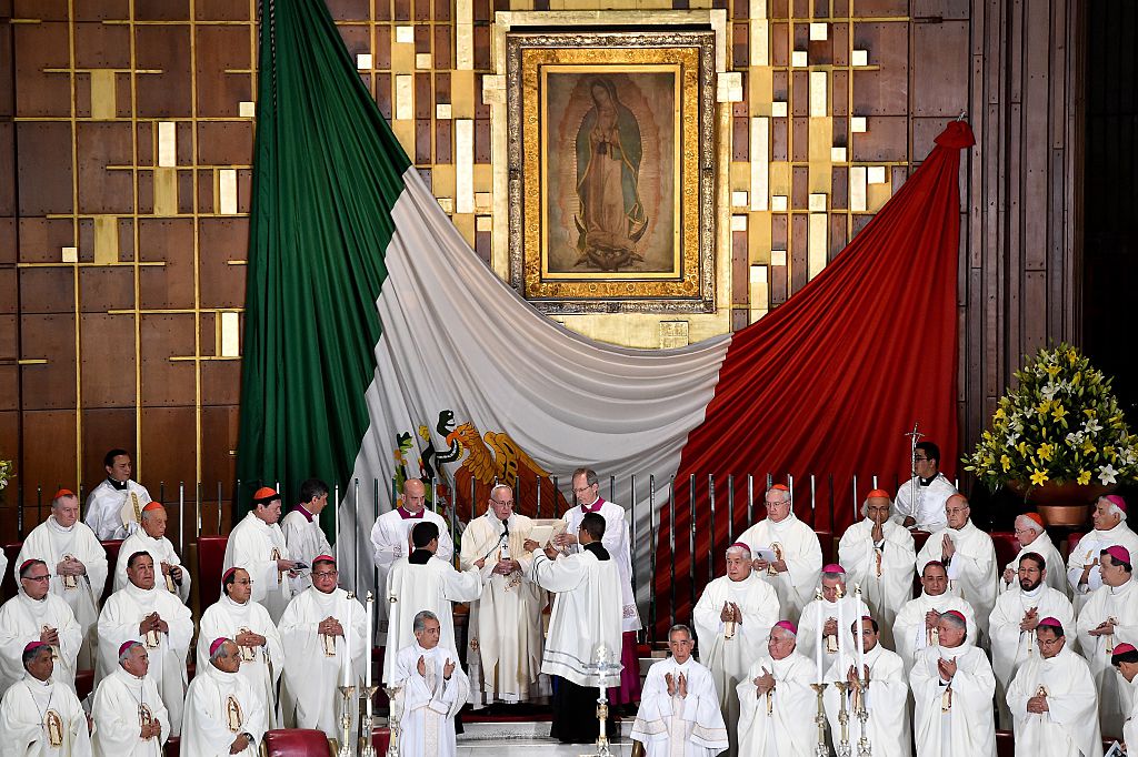 Pope Francis (C) officiates a Holy Mass in the Basilica of Our Lady of Guadalupe in Mexico on February 13, 2016. Pope Francis is in Mexico for a trip encompassing two of the defining themes of his papacy: bridge-building diplomacy and his concern for migrants seeking a better life. AFP PHOTO / GABRIEL BOUYS / AFP / GABRIEL BOUYS (Photo credit should read GABRIEL BOUYS/AFP/Getty Images)