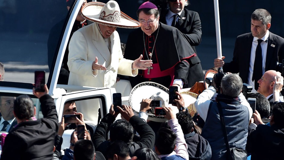 Pope Francis receives a traditional Mexican sombrero and greets people on his ride in the popemobile to the Zocalo in Mexico City on February 13, 2016. AFP PHOTO/ Mario Vazquez / AFP / MARIO VAZQUEZ (Photo credit should read MARIO VAZQUEZ/AFP/Getty Images)