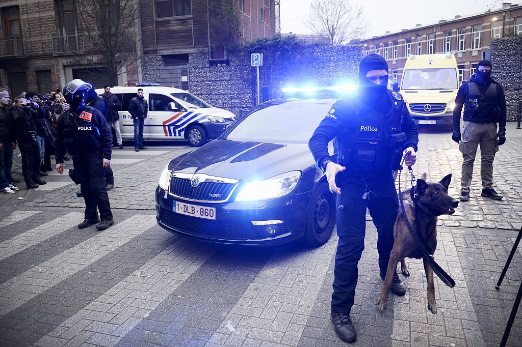 Policemen block a road, near the scene of a police raid in the Molenbeek-Saint-Jean district in Brussels, on March 18, 2016, as part of the investigation into the Paris November attacks. The main suspect in the jihadist attacks on Paris in November, Salah Abdeslam, was arrested in a raid in Brussels on March 18, French police sources said. / AFP / BELGA / DIRK WAEM / Belgium OUT (Photo credit should read DIRK WAEM/AFP/Getty Images)