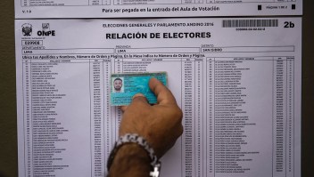 A voter looks for his name in an electoral roll at a polling station during presidential elections in Lima on April 10, 2016. Almost 23 million Peruvians in Peru and abroad are expected to decide whether Keiko Fujimori, daughter of an ex-president jailed for massacres, should become their first female head of state in an election marred by alleged vote-buying and guerrilla attacks that killed four. / AFP / MARTIN BERNETTI (Photo credit should read MARTIN BERNETTI/AFP/Getty Images)