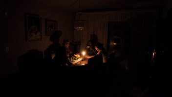 A family sit at a candle lit table in the state of Barinas, 600 km west of Caracas on April 25, 2016. Recession-hit Venezuela will turn off the electricity supply in its 10 most populous states for four hours a day for 40 days to deal with a severe power shortage, the government said. It is the latest drastic measure by the government in a crisis that already has Venezuelans queuing for hours to buy scarce supplies in shops. / AFP / JUAN BARRETO (Photo credit should read JUAN BARRETO/AFP/Getty Images)