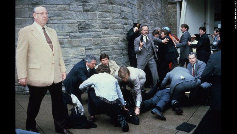 23374 08: Chaos Surrounds Shooting Victims Immediately After The Assassination Attempt On President Reagan, March 30, 1981, By John Hinkley Jr. Outside The Hilton Hotel In Washington, Dc. Injured In The Shooting Are Press Secretary James Brady And Agent Timothy Mccarthy. (Photo By Dirck Halstead/Getty Images)