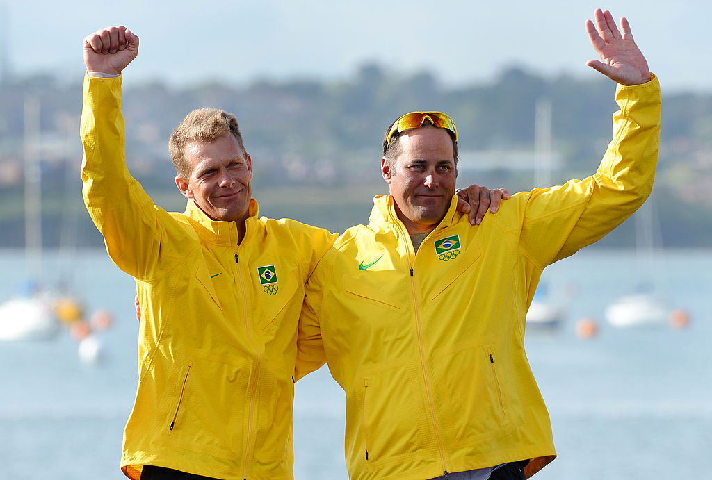 Bronze medalists Brazil's Bruno Prada (L) and Robert Scheidt celebrate on the podium of the Star sailing class at the London 2012 Olympic Games, in Weymouth on August 5, 2012. AFP PHOTO/William WEST (Photo credit should read WILLIAM WEST/AFP/GettyImages)
