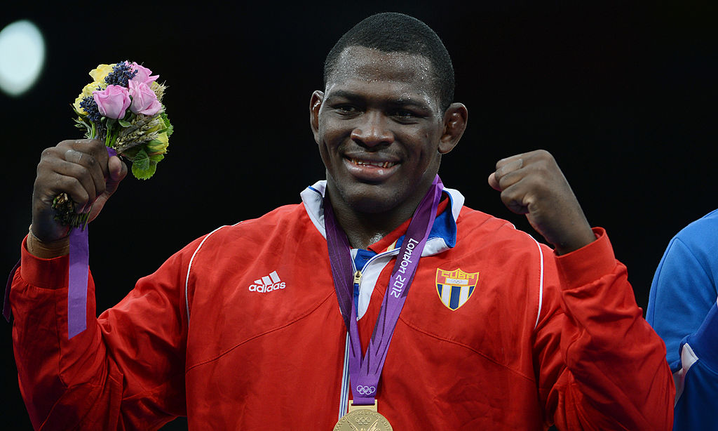 Gold Medalist Cuban Mijain Lopez Nunez poses for a photograph on the podium during the medal ceremony of the men's 120 kg greco roman style at the London 2012 Olympic Games in London on August 6, 2012. AFP PHOTO /ADEK BERRY (Photo credit should read ADEK BERRY/AFP/GettyImages)