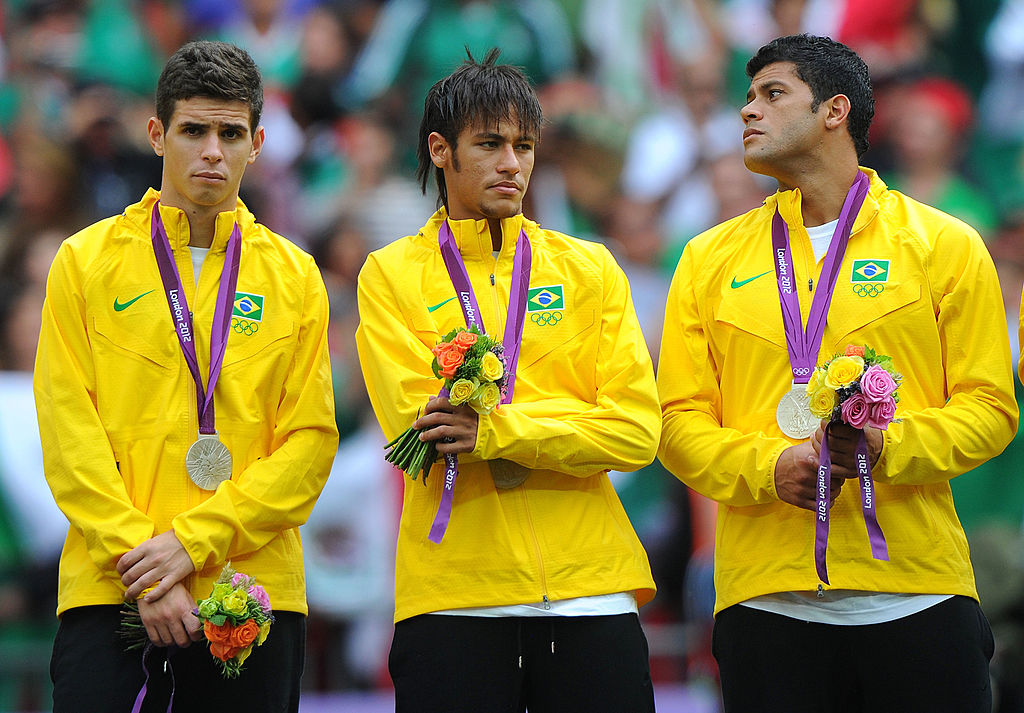 LONDON, ENGLAND - AUGUST 11: Oscar of Brazil, Neymar of Brazil and Hulk of Brazil look on with their silver medals during the medal ceremony for the Men's Football Final between Brazil and Mexico on Day 15 of the London 2012 Olympic Games at Wembley Stadium on August 11, 2012 in London, England. (Photo by Michael Regan/Getty Images)