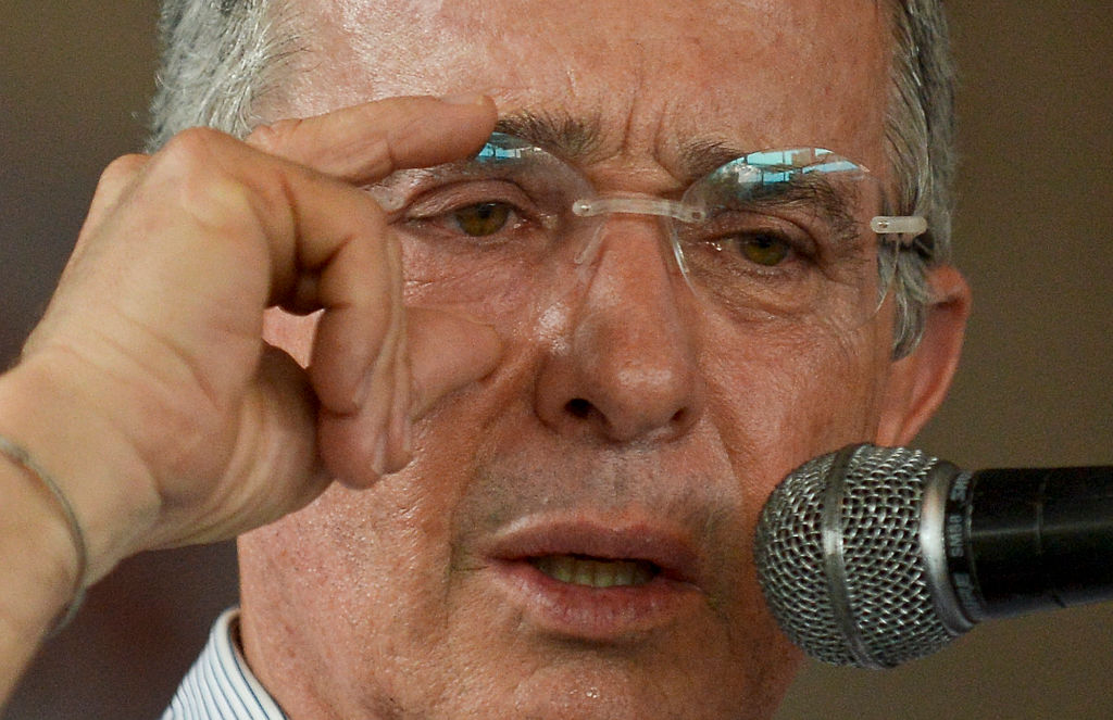 Colombian former president, senator Alvaro Uribe speaks during a signature protest "For the Peace We Want" (Por la Paz Que Queremos) against the peace talks between the Colombian government leaded by President Juan Manuel Santos and the FARC guerrillas in Cali, Colombia, on June 22, 2016. Colombia's government and the FARC guerrilla force agreed Wednesday on a definitive ceasefire, taking one of the last steps towards ending Latin America's longest civil war. The announcement heralds an end to a half-century conflict that has killed hundreds of thousands of people in the jungles of the major cocaine-producing country. / AFP / LUIS ROBAYO (Photo credit should read LUIS ROBAYO/AFP/Getty Images)