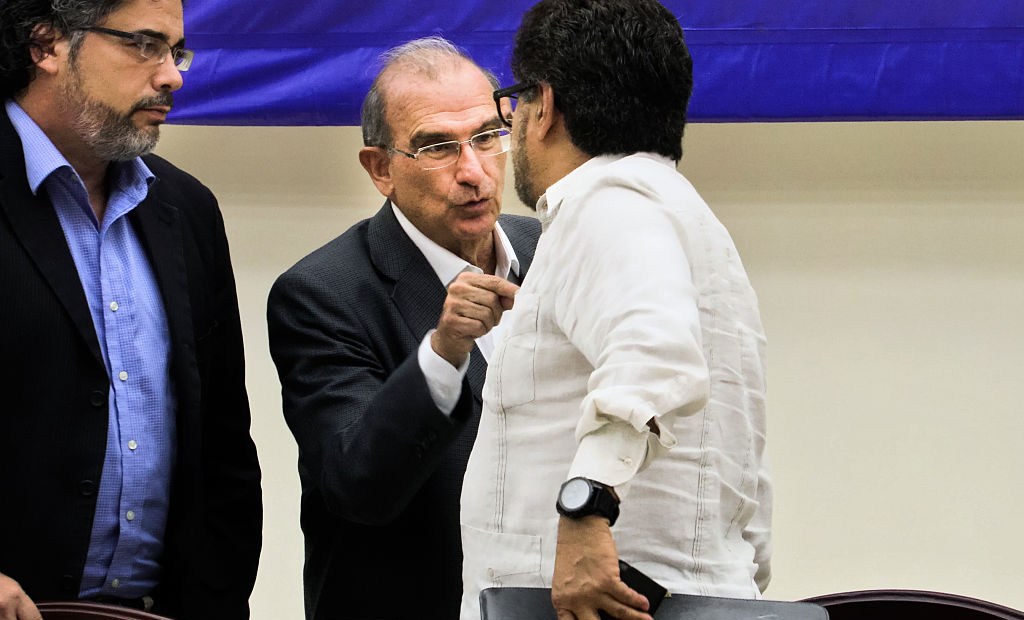 The head of the Colombian government's delegation for peace talks Humberto de la Calle (C) and FARC leftist guerilla member Ivan Marquez (R) speak next to Cuban Guarantor Rodolfo Benitez before a press conference at the Convention Palace in Havana, on August 12, 2016. / AFP / ADALBERTO ROQUE (Photo credit should read ADALBERTO ROQUE/AFP/Getty Images)