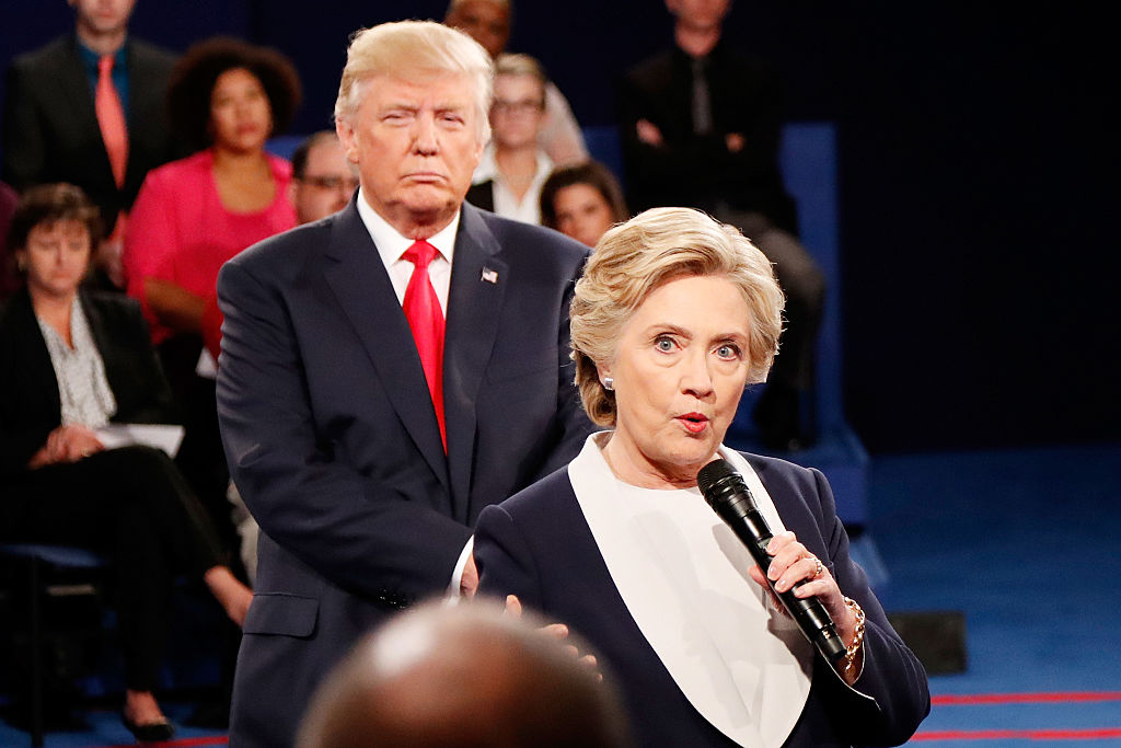 ST LOUIS, MO - OCTOBER 09: Democratic presidential nominee former Secretary of State Hillary Clinton (R) speaks as Republican presidential nominee Donald Trump looks on during the town hall debate at Washington University on October 9, 2016 in St Louis, Missouri. This is the second of three presidential debates scheduled prior to the November 8th election. (Photo by Rick Wilking-Pool/Getty Images)