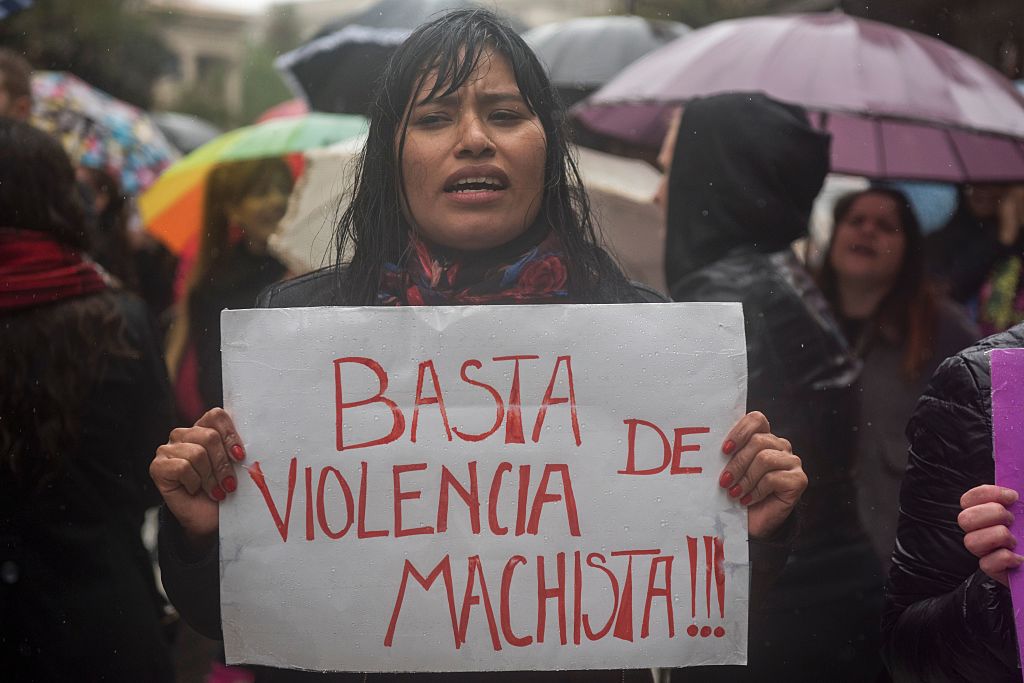 Women stop work and other activities for an hour to join a "women's strike" organized after the brutal killing of a 16-year-old girl, in Buenos Aires, on October 19, 2016. The brutal killing of a teenager who was allegedly raped and impaled on a spike by drug dealers has sparked outrage in Argentina. Lucia Perez, a high school student in the resort city of Mar del Plata, died on October 8 after being brought to the hospital by two men who said she had overdosed on drugs. But after doctors noticed signs of violent sexual penetration, investigators pieced together a different story. / AFP / Eitan ABRAMOVICH (Photo credit should read EITAN ABRAMOVICH/AFP/Getty Images)