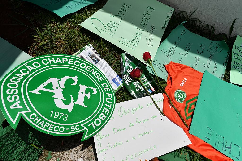 People pay tribute to the players of Brazilian team Chapecoense Real who were killed in a plane accident in the Colombian mountains, at the club's Arena Conda stadium in Chapeco, in the southern Brazilian state of Santa Catarina, on November 29, 2016. Players of the Chapecoense were among 81 people on board the doomed flight that crashed into mountains in northwestern Colombia, in which officials said just six people were thought to have survived, including three of the players. Chapecoense had risen from obscurity to make it to the Copa Sudamericana finals scheduled for Wednesday against Atletico Nacional of Colombia. / AFP / Nelson ALMEIDA (Photo credit should read NELSON ALMEIDA/AFP/Getty Images)