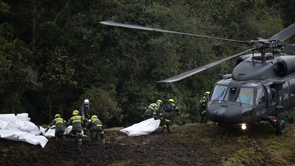 TOPSHOT - Police rescue teams recover the bodies of victims of the LAMIA airlines charter that crashed in the mountains of Cerro Gordo, municipality of La Union, Colombia, on November 29, 2016 carrying members of the Brazilian football team Chapecoense Real. A charter plane carrying the Brazilian football team crashed in the mountains in Colombia late Monday, killing as many as 75 people, officials said. / AFP / STR / Raul ARBOLEDA (Photo credit should read RAUL ARBOLEDA/AFP/Getty Images)