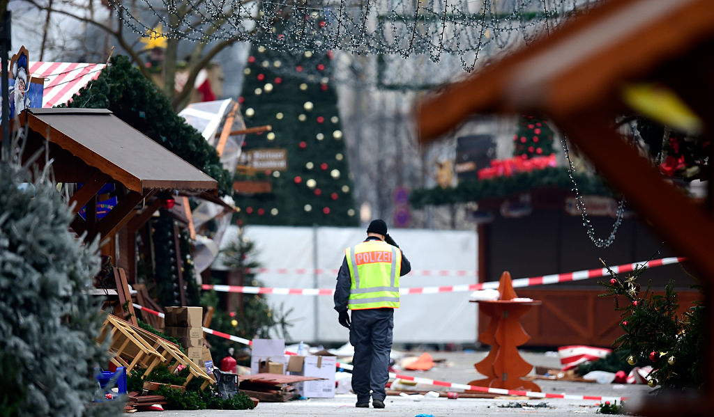 A policeman walks at the Christmas market near the Kaiser-Wilhelm-Gedaechtniskirche (Kaiser Wilhelm Memorial Church), the day after a terror attack, in central Berlin, on December 20, 2016. German police said they were treating as "a probable terrorist attack" the killing of 12 people when the speeding lorry cut a bloody swath through the packed Berlin Christmas market. / AFP / Tobias SCHWARZ (Photo credit should read TOBIAS SCHWARZ/AFP/Getty Images)
