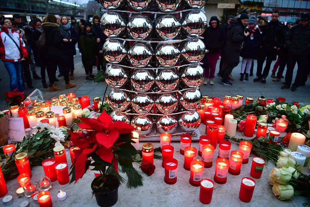 Candles are lit on December 20, 2016 at a makeshift memorial in front of the Kaiser-Wilhelm-Gedaechtniskirche (Kaiser Wilhelm Memorial Church) in Berlin, where a truck crashed the day before into a Christmas market. Twelve people were killed and almost 50 wounded, 18 seriously, when the lorry tore through the crowd on December 19, 2016, smashing wooden stalls and crushing victims, in scenes reminiscent of July's deadly attack in the French Riviera city of Nice. / AFP / John MACDOUGALL (Photo credit should read JOHN MACDOUGALL/AFP/Getty Images)