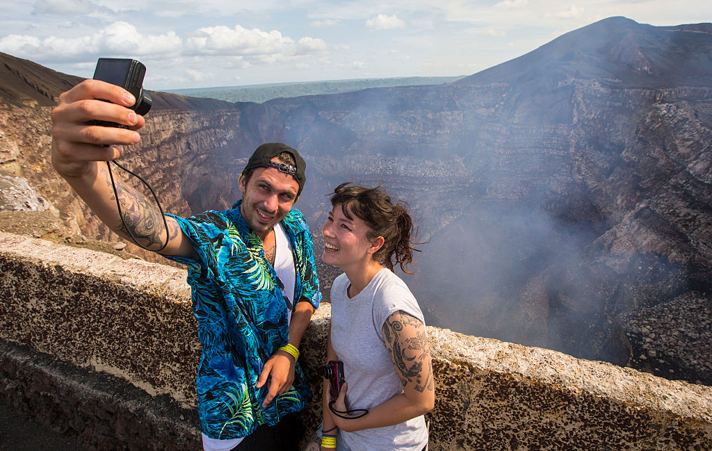 Tourists make a selfie at the crater of the Masaya Volcano in Masaya, some 30km from Managua on May 19, 2016.