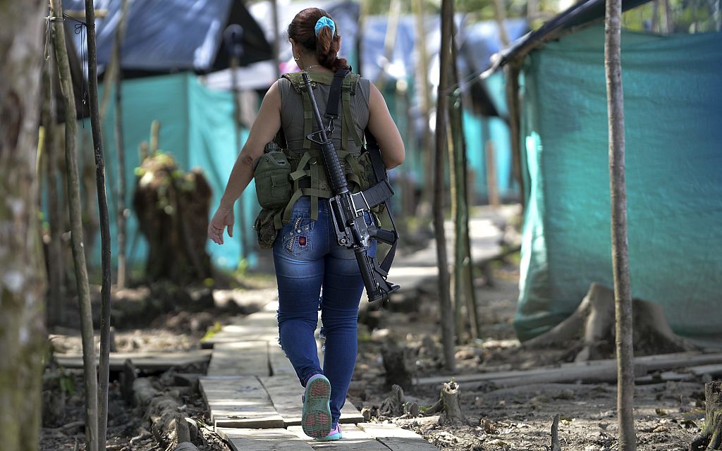 FARC guerrilla fighters walk in the Front 34 Alberto Martinez encampment after the New Year's celebration in Vegaez municipality, Antioquia department, Colombia on January 1, 2017. Colombia's Congress on Wednesday passed a law granting an amnesty to the Marxist FARC rebels as part of the country's peace deal, a development the government hailed as "historic." / AFP / STR / RAUL ARBOLEDA (Photo credit should read RAUL ARBOLEDA/AFP/Getty Images)