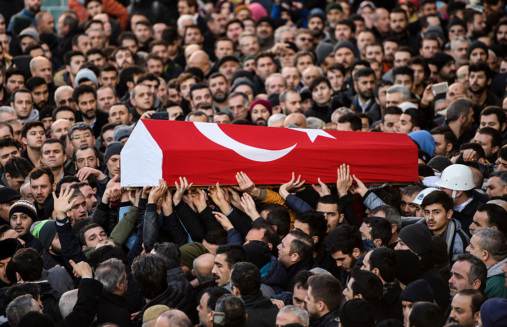 People carry the coffin of Yunus Gormek, 23, one of the victims of the Reina night club attack, during his funeral ceremony on January 2, 2017 in Istanbul. The Islamic State jihadist group on January 2, 2017 claimed the shooting rampage inside a glamorous Istanbul nightclub on New Year's night that killed 39 people, as police hunted the attacker who remains on the run. With foreigners making up the majority of those killed in Sunday's attack, families were due to reclaim the bodies of more than two dozen non-Turkish and mainly Arab victims. / AFP / BULENT KILIC (Photo credit should read BULENT KILIC/AFP/Getty Images)