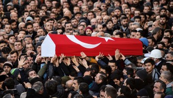 People carry the coffin of Yunus Gormek, 23, one of the victims of the Reina night club attack, during his funeral ceremony on January 2, 2017 in Istanbul. The Islamic State jihadist group on January 2, 2017 claimed the shooting rampage inside a glamorous Istanbul nightclub on New Year's night that killed 39 people, as police hunted the attacker who remains on the run. With foreigners making up the majority of those killed in Sunday's attack, families were due to reclaim the bodies of more than two dozen non-Turkish and mainly Arab victims. / AFP / BULENT KILIC (Photo credit should read BULENT KILIC/AFP/Getty Images)