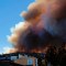TOPSHOT - Smoke billows from a forest near Valparaiso, in Chile, on January 02, 2017 as the fire threatens to reach the city's port, authorities have declared a red alert in the area. / AFP / Daniel RETAMAL / (Photo credit should read DANIEL RETAMAL/AFP/Getty Images)