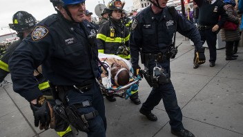 NEW YORK, NY - JANUARY 4: Members of the New York City Police Department and New York City Fire Department carry an injured person away from Atlantic Terminal, January 4, 2017 in the Brooklyn borough of New York City. A Long Island Railroad train derailed at Atlantic Terminal on Wednesday morning. (Photo by Drew Angerer/Getty Images)