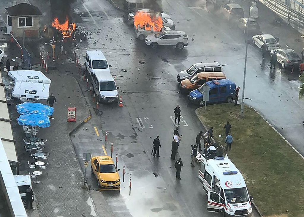 Cars burn in the street at the site of an explosion in front of the courthouse in Izmir on January 5, 2017. A car bomb exploded outside a courthouse in the western Turkish city of Izmir, wounding at least 10 people and sparking clashes in which at least two 'terrorists' were killed, officials and reports said.Several ambulances were rushed to the scene after the blast outside the prosecutors and judges' entrance to the court in the usually peaceful city on the Aegean Sea, the channel said. / AFP / DOGAN NEWS AGENCY / DHA (Photo credit should read DHA/AFP/Getty Images)
