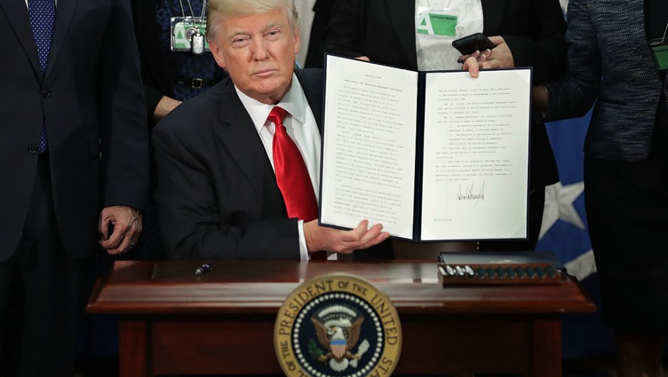 WASHINGTON, DC - JANUARY 25: (AFP OUT) U.S. President Donald Trump (C) displays one of the four executive orders he signed during a visit to the Department of Homeland Security January 25, 2017 in Washington, DC. Trump signed four executive orders related to domestic security and to begin the process of building a wall along the U.S.-Mexico border. (Photo by Chip Somodevilla/Getty Images)