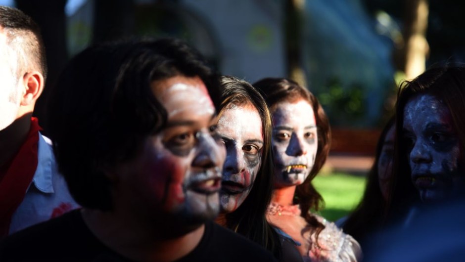 People hold a demonstration in the center of Asuncion on February 3, 2017 to protest the campaign by President Horacio Cartes' supporters in the governing Colorado Party to collect signatures seeking a constitutional reform with the aim of pushing for presidential reelection, which is banned by the constitution. Many of the demonstrators dressed as zombies, in the style of the popular series "The Walking Dead", to mock the appearance of the names of dead people on the lists of signatures demanding a constitutional reform ahead of the 2018 presidential elections. / AFP / NORBERTO DUARTE (Photo credit should read NORBERTO DUARTE/AFP/Getty Images)