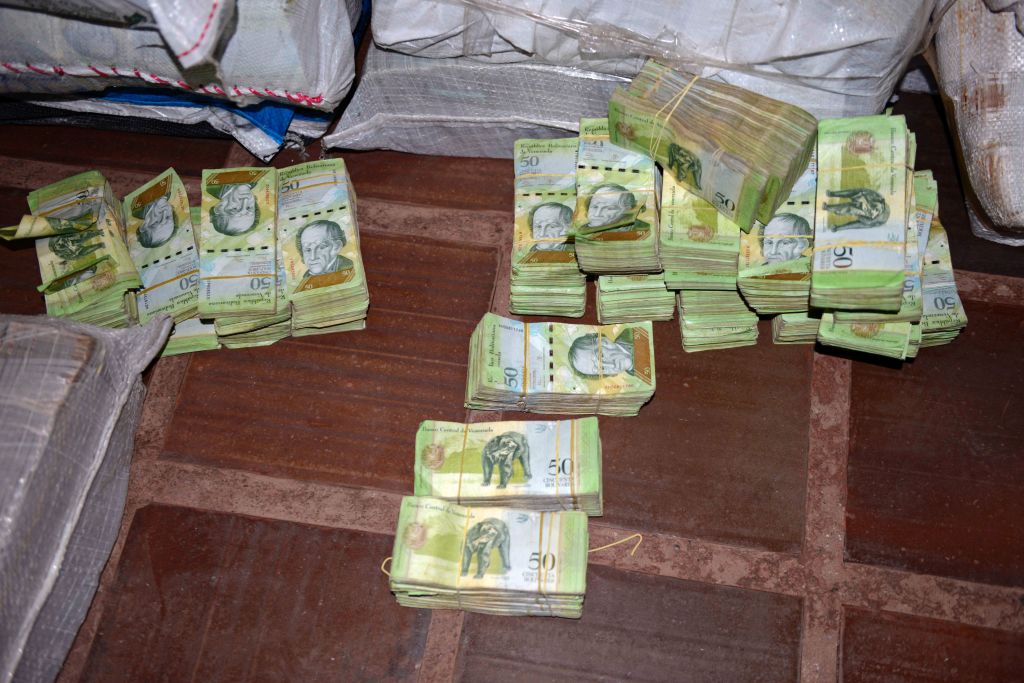 Picture of 50-Venezuelan Bolivar bills, part of a hoard weighing about 30 tons seized by Paraguay's National Police at a house in Salto del Guaira, department of Canindeyu in the border with Brazil, about 420 km east of Asuncion, on February 14, 2017. In January Venezuela released new bigger denomination banknotes as President Nicolas Maduro wanted to scrap the 100-bolivar note, claiming they are being hoarded by "mafias." / AFP / STR (Photo credit should read STR/AFP/Getty Images)