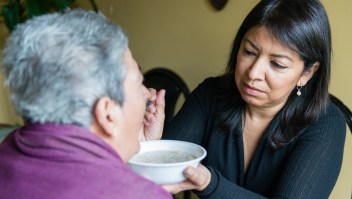Tania Yanes feeds oatmeal to her mother, Blanca Rosa Rivera, on Sunday, November 27, 2016. “My mom is 100 percent dependent on us.” says Yanes. (Heidi de Marco/KHN)