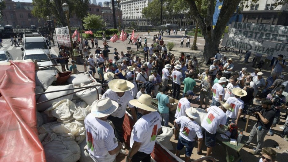 Mate growers from the province of Misiones, northeastern Argentina, unload from a truck sacks with packages of mate to be given for free at Plaza de Mayo square in Buenos Aires, on March 2, 2017, during a protest in the hope to inform buyers and legislators about their situation. The growers gave away free to the passers-by 30,000 packages of mate in a protest against the low price of their product. / AFP PHOTO / JUAN MABROMATA (Photo credit should read JUAN MABROMATA/AFP/Getty Images)