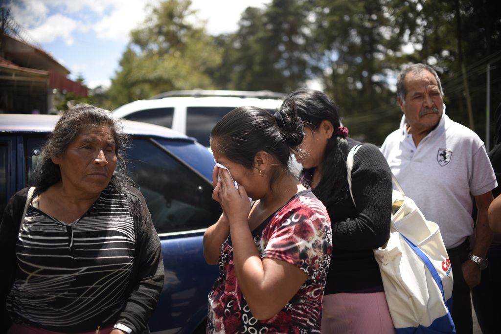 Relatives cry outside the children's shelter Virgen de la Asuncion after a fire at the facility killed at least 19 people, in San Jose Pinula, about 30km east of Guatemala City, on March 8, 2017. At least 19 people died in a fire at a children's shelter in Guatemala, a spokesman for the local fire service said. It was not immediately known how many of the bodies were those of children. The center, supervised by state social welfare authorities, hosts minors who are victims of family mistreatment. The facility has been the target of multiple complaints alleging abuse, and several children have run away. / AFP PHOTO / JOHAN ORDONEZ (Photo credit should read JOHAN ORDONEZ/AFP/Getty Images)