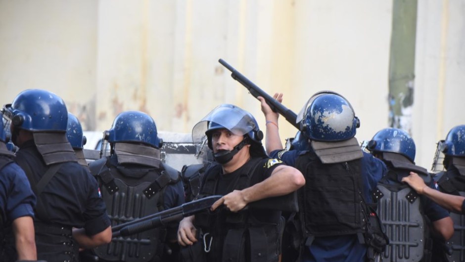 Riot police agents crack down on a protest against the approval of a constitutional amendment for presidential reelection, outside Congress in Asuncion, on March 31, 2017. Ruling Colorado party senators and their allies, in a so-called "parallel Senate", unexpectedly approved an amendment Friday that would allow President Horacio Cartes to run for reelection in 2018, triggering protests that led to clashes between opposition demonstrators and the police. / AFP PHOTO / NORBERTO DUARTE (Photo credit should read NORBERTO DUARTE/AFP/Getty Images)