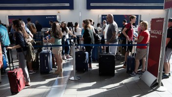 NEW YORK, NY - AUGUST 8: Travelers wait in line at the Delta baggage drop at LaGuardia Airport , August 8, 2016 in the Queens borough of New York City. Delta flights around the globe were grounded and delayed on Monday morning due to a system outage. (Photo by Drew Angerer/Getty Images)