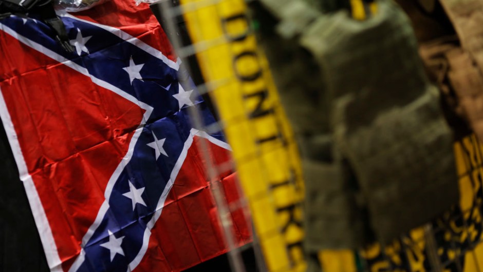 A Confederate battle flag and a Gadsden flag are seen with body armor on display at a National Rifle Association outdoor sports trade show on February 10, 2017 in Harrisburg, Pennsylvania. The Great American Outdoor Show, a nine day event celebrating hunting, fishing and outdoor traditions, features over 1,000 exhibitors ranging from shooting manufacturers to outfitters to fishing boats and RVs, and archery to art. / AFP / DOMINICK REUTER (Photo credit should read DOMINICK REUTER/AFP/Getty Images)