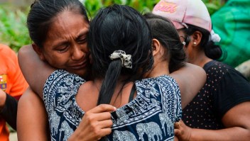 A woman cries when she is reunited with her family amidst the rubble left by mudslides following heavy rains in Mocoa, Putumayo department, southern Colombia on April 2, 2017. The death toll from a devastating landslide in the Colombian town of Mocoa stood at around 200 on Sunday as rescuers clawed through piles of muck and debris in search of survivors. / AFP PHOTO / LUIS ROBAYO (Photo credit should read LUIS ROBAYO/AFP/Getty Images)