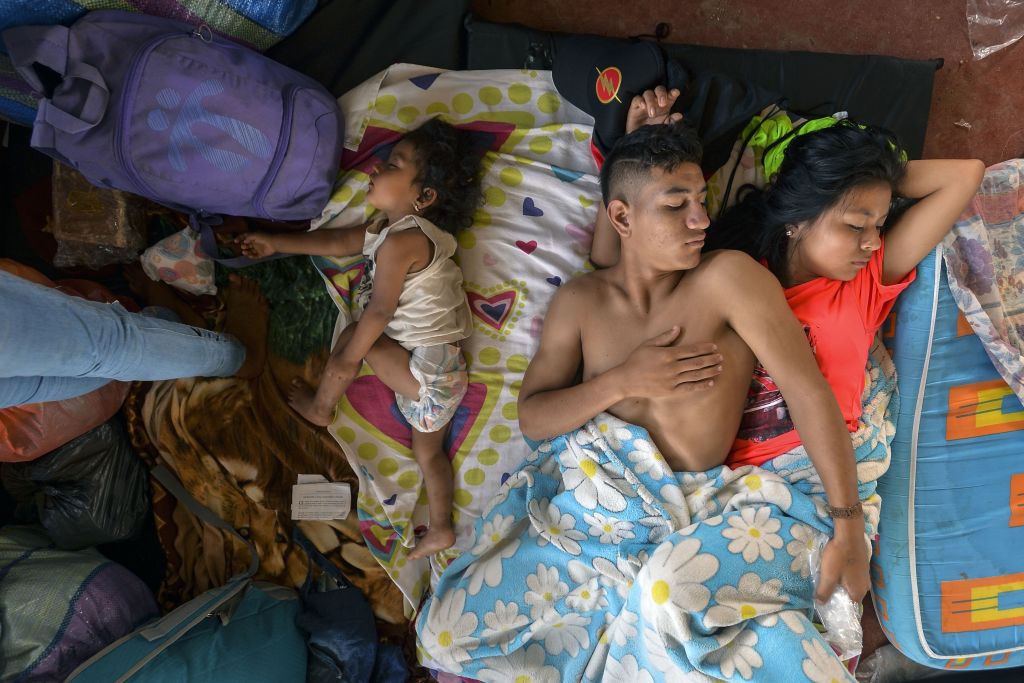 TOPSHOT - A family rests at a shelter in Mocoa, Putumayo department, southern Colombia on April 3, 2017. Residents of Mocoa were Monday desperately searching for loved ones missing since devastating mudslides slammed into the remote Colombian town, as the death toll soared to over 250, including 43 children. / AFP PHOTO / LUIS ROBAYO (Photo credit should read LUIS ROBAYO/AFP/Getty Images)
