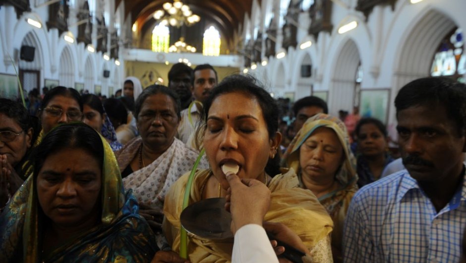 A Indian Christian worshippers receives Holy Communion during Palm Sunday Mass in Chennai on April 9, 2017. Palm Sunday marks the sixth and last Sunday of Lent and the beginning of Holy Week. / AFP PHOTO / ARUN SANKAR (Photo credit should read ARUN SANKAR/AFP/Getty Images)