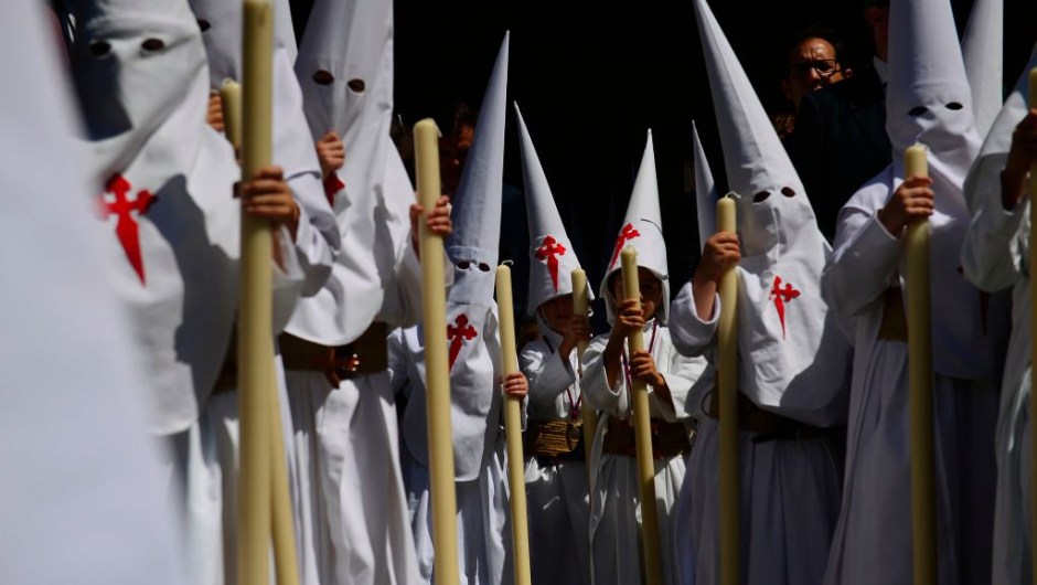 Penitents of the 'La Borriquita' brotherhood parade in Sevilla during the Holy Week on April 9, 2017. Christian believers around the world mark the Holy Week of Easter in celebration of the crucifixion and resurrection of Jesus Christ. / AFP PHOTO / CRISTINA QUICLER (Photo credit should read CRISTINA QUICLER/AFP/Getty Images)