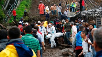 Rescuers carry a corpse after mudslides in Manizales, Caldas department, Colombia on April 19, 2017. Flooding and mudslides in central Colombia have killed at least eleven people, the Red Cross said Wednesday, causing alarm in a country still recovering from mudslides that killed hundreds / AFP PHOTO / STRINGER (Photo credit should read STRINGER/AFP/Getty Images)