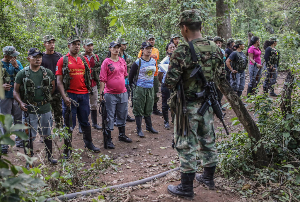 FARC guerrillas fall in during a review at their camp in the Transitional Standardization Zone in Pondores, La Guajira department, Colombia on April 3, 2017. The Colombian government reported that the FARC guerrillas provided a total list with the names of the 6,084 members of the rebel group who have gathered in 26 "standardization zones" across the country, where they are building accomodations that will house them until the end of the disarmament process, outlined in the peace agreement reached in November 2016. / AFP PHOTO / Joaquin Sarmiento (Photo credit should read JOAQUIN SARMIENTO/AFP/Getty Images)