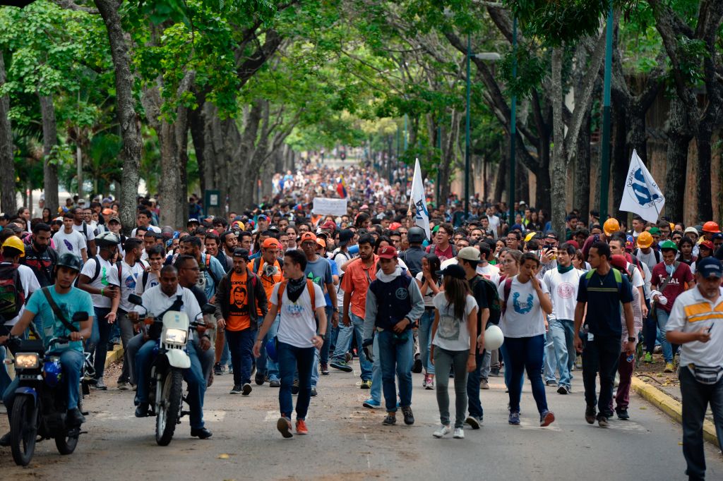 Venezuela's Central University students march to the education ministry, during a protest against President Nicolas Maduro, in Caracas on May 8, 2017. Venezuela's opposition mobilized Monday in fresh street protests against President Nicolas Maduro's efforts to reform the constitution in a deadly political crisis. Supporters of the opposition Democratic Unity Roundtable (MUD) gathered in eastern Caracas to march to the education ministry under the slogan "No to the dictatorship." / AFP PHOTO / FEDERICO PARRA (Photo credit should read FEDERICO PARRA/AFP/Getty Images)