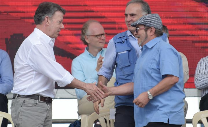 FARC rebel leader Rodrigo Londono Echeverri, known as "Timochenko"(R), Colombian president Juan Manuel Santos (L) and the UN Secretary-General's Special Representative for Colombia and Head of the UN Mission to Colombia, Jean Arnault(C) attend the final act of abandonment of arms and its end as an armed group at Transitional Standardization Zone Mariana Paez, Buena Vista, Mesetas municipality, Colombia on June 27, 2017. / AFP PHOTO / RAUL ARBOLEDA (Photo credit should read RAUL ARBOLEDA/AFP/Getty Images)
