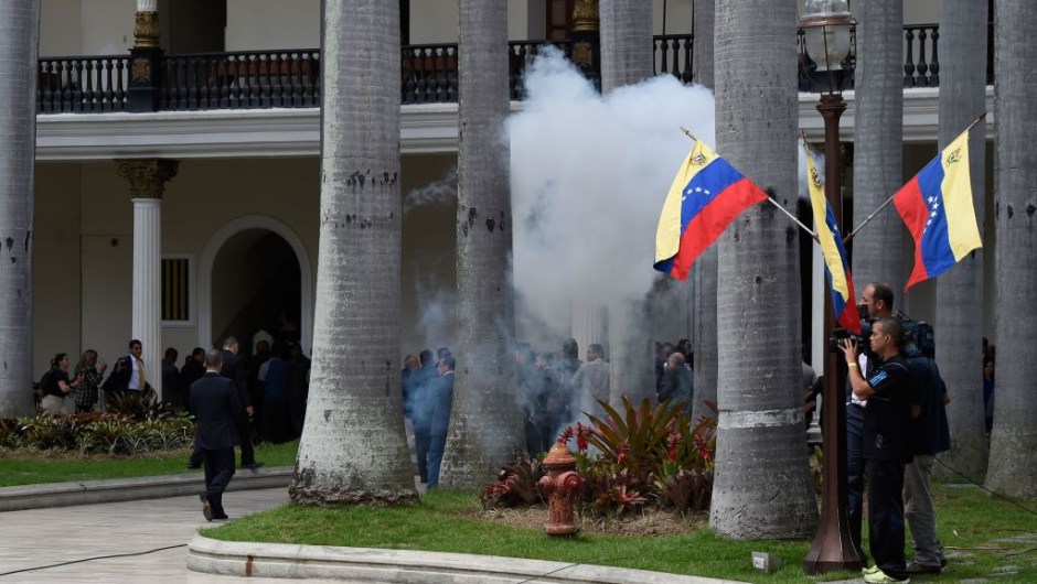Supporters of Venezuelan President Nicolas Maduro storm the National Assembly building in Caracas on July 5, 2017 as opposition deputies hold a special session on Independence Day. A political and economic crisis in the oil-producing country has spawned often violent demonstrations by protesters demanding President Nicolas Maduro's resignation and new elections. The unrest has left 91 people dead since April 1. / AFP PHOTO / Juan BARRETO (Photo credit should read JUAN BARRETO/AFP/Getty Images)