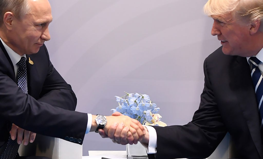 TOPSHOT - US President Donald Trump and Russia's President Vladimir Putin shake hands during a meeting on the sidelines of the G20 Summit in Hamburg, Germany, on July 7, 2017. / AFP PHOTO / SAUL LOEB (Photo credit should read SAUL LOEB/AFP/Getty Images)