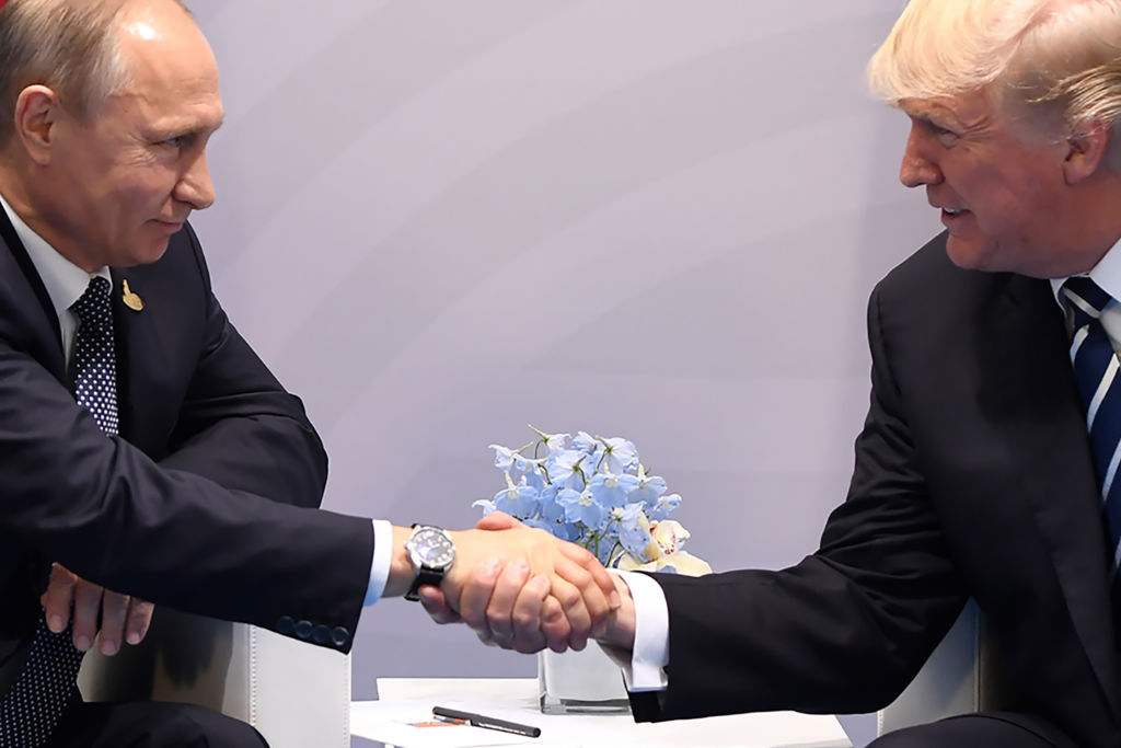 TOPSHOT - US President Donald Trump and Russia's President Vladimir Putin shake hands during a meeting on the sidelines of the G20 Summit in Hamburg, Germany, on July 7, 2017. / AFP PHOTO / SAUL LOEB (Photo credit should read SAUL LOEB/AFP/Getty Images)