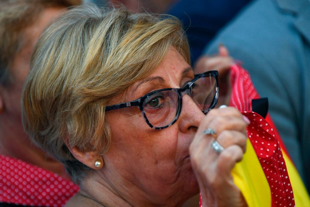 A woman cries as she observes a minute of silence for the victims of the Barcelona attack at Puerta del Sol in Madrid on August 18, 2017, a day after a van ploughed into the crowd, killing 13 persons and injuring over 100 on the Rambla in Barcelona. Drivers have ploughed on August 17, 2017 into pedestrians in two quick-succession, separate attacks in Barcelona and another popular Spanish seaside city, leaving 13 people dead and injuring more than 100 others. In the first incident, which was claimed by the Islamic State group, a white van sped into a street packed full of tourists in central Barcelona on Thursday afternoon, knocking people out of the way and killing 13 in a scene of chaos and horror. Some eight hours later in Cambrils, a city 120 kilometres south of Barcelona, an Audi A3 car rammed into pedestrians, injuring six civilians -- one of them critical -- and a police officer, authorities said. / AFP PHOTO / GABRIEL BOUYS (Photo credit should read GABRIEL BOUYS/AFP/Getty Images)