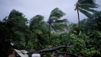TOPSHOT - A picture taken on September 19, 2017 shows the powerful winds and rains of hurricane Maria battering the city of Petit-Bourg on the French overseas Caribbean island of Guadeloupe. Hurricane Maria strengthened into a "potentially catastrophic" Category Five storm as it barrelled into eastern Caribbean islands still reeling from Irma, forcing residents to evacuate in powerful winds and lashing rain. / AFP PHOTO / Cedrik-Isham Calvados (Photo credit should read CEDRIK-ISHAM CALVADOS/AFP/Getty Images)