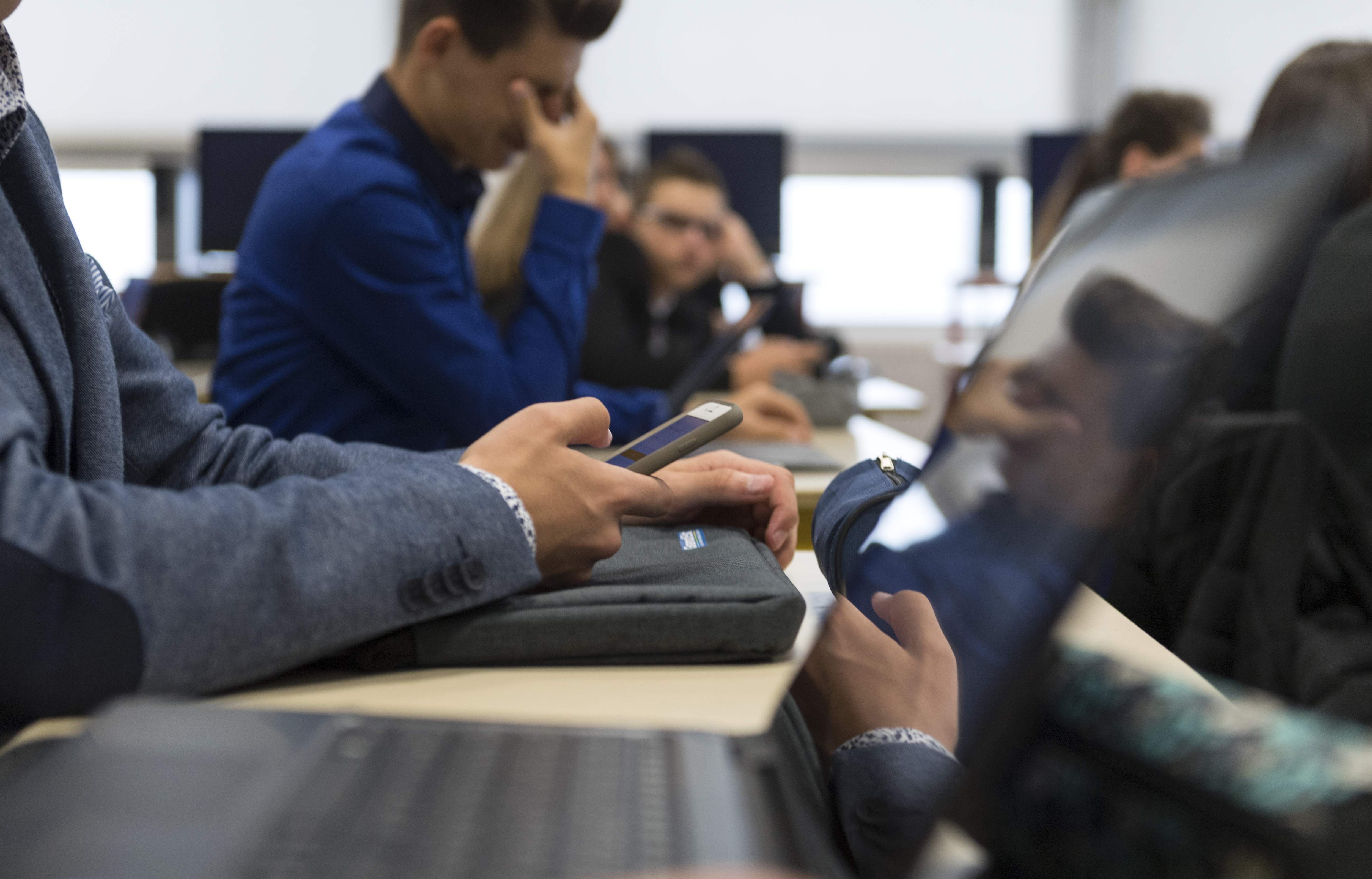 In this photograph taken on September 26, 2017, high school students use smartphones and tablet computers at the vocational school in Bischwiller, eastern France. Since the beginning of the school year in eastern France some 31,000 high school pupils have replaced their traditional textbooks by computers and tablets , a move popular with students but opinion is divided among teachers and parents. / AFP PHOTO / PATRICK HERTZOGPATRICK HERTZOG/AFP/Getty Images