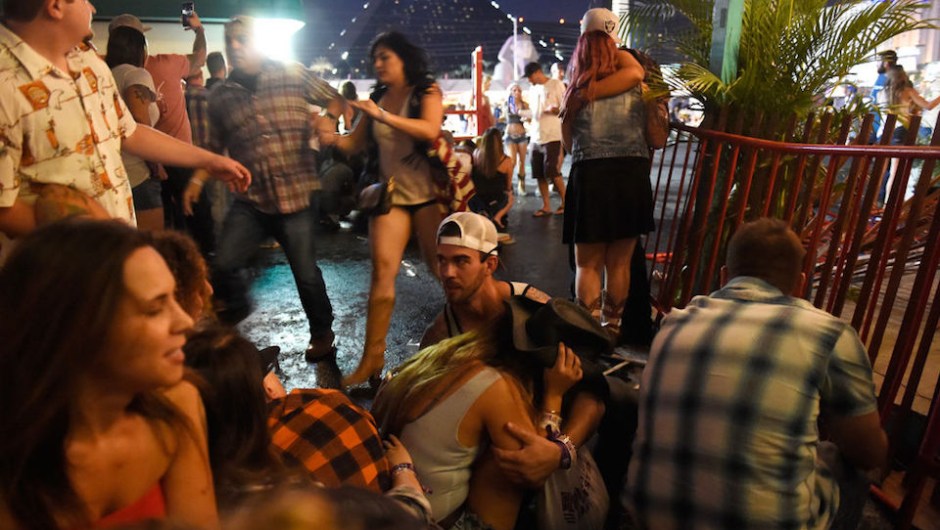 LAS VEGAS, NV - OCTOBER 01: People run for cover at the Route 91 Harvest country music festival after apparent gun fire was heard on October 1, 2017 in Las Vegas, Nevada. There are reports of an active shooter around the Mandalay Bay Resort and Casino. (Photo by David Becker/Getty Images)